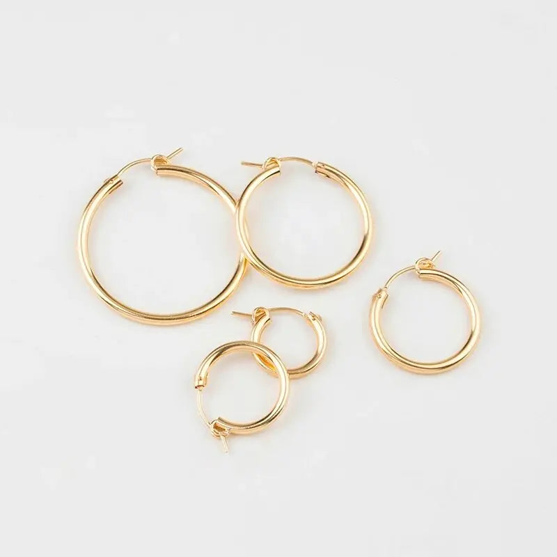 Polished yellow gold 585 oval hoop earrings by QIAO, lightweight and versatile for elegant style.