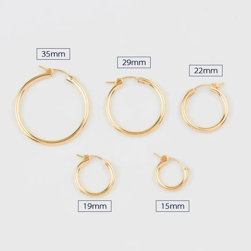 Polished yellow gold 585 oval hoop earrings by QIAO, lightweight and versatile for elegant style.